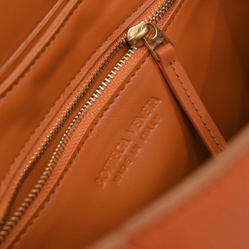 Bottega Veneta BV 666870 Cassette Intreccio grained leather cross-body bag Orange