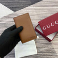 Gucci 818953 GG Emblem bi-fold embossed card case Brown