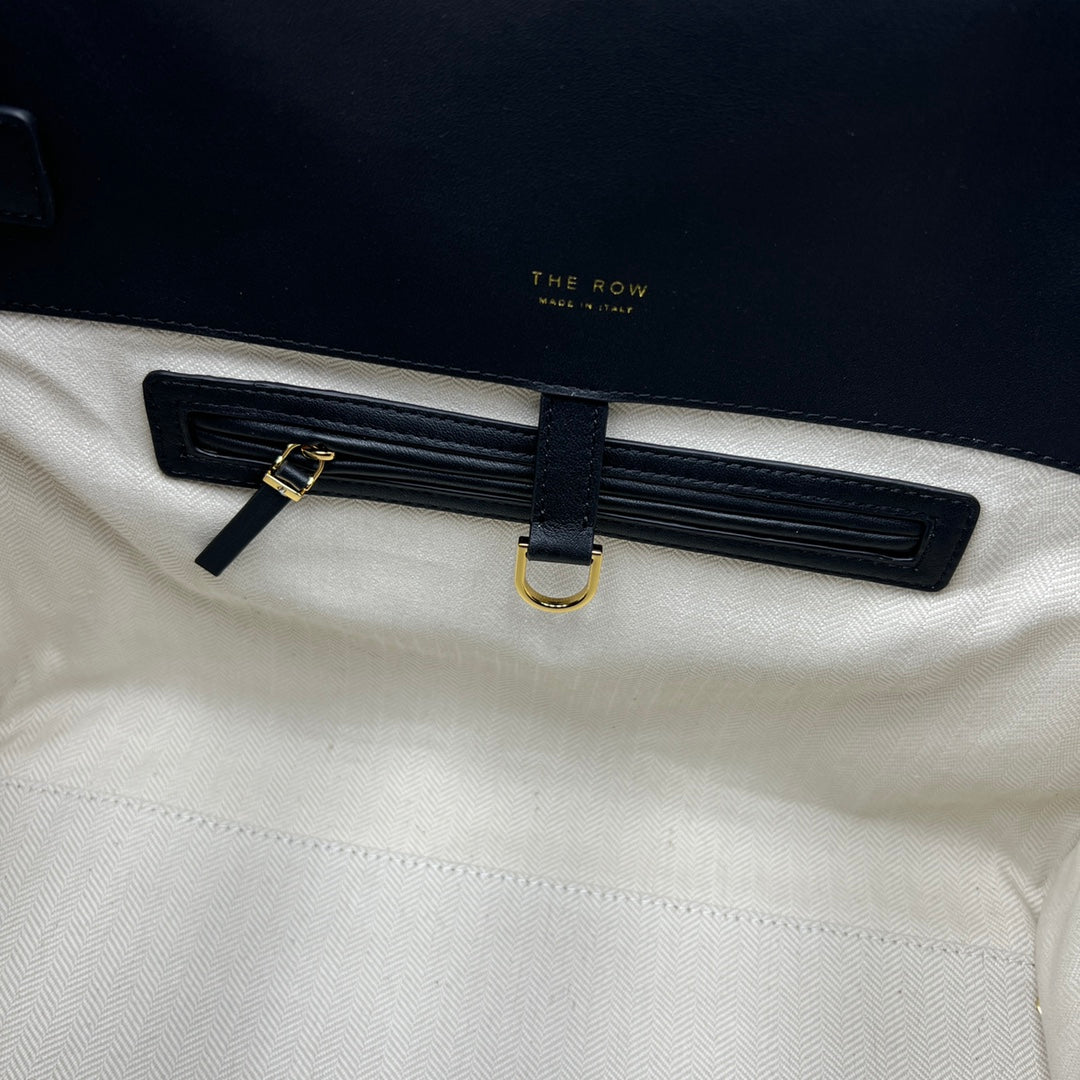 The Row W1255L72 Calfskin Margaux 15 Air buckled textured-leather tote T10990