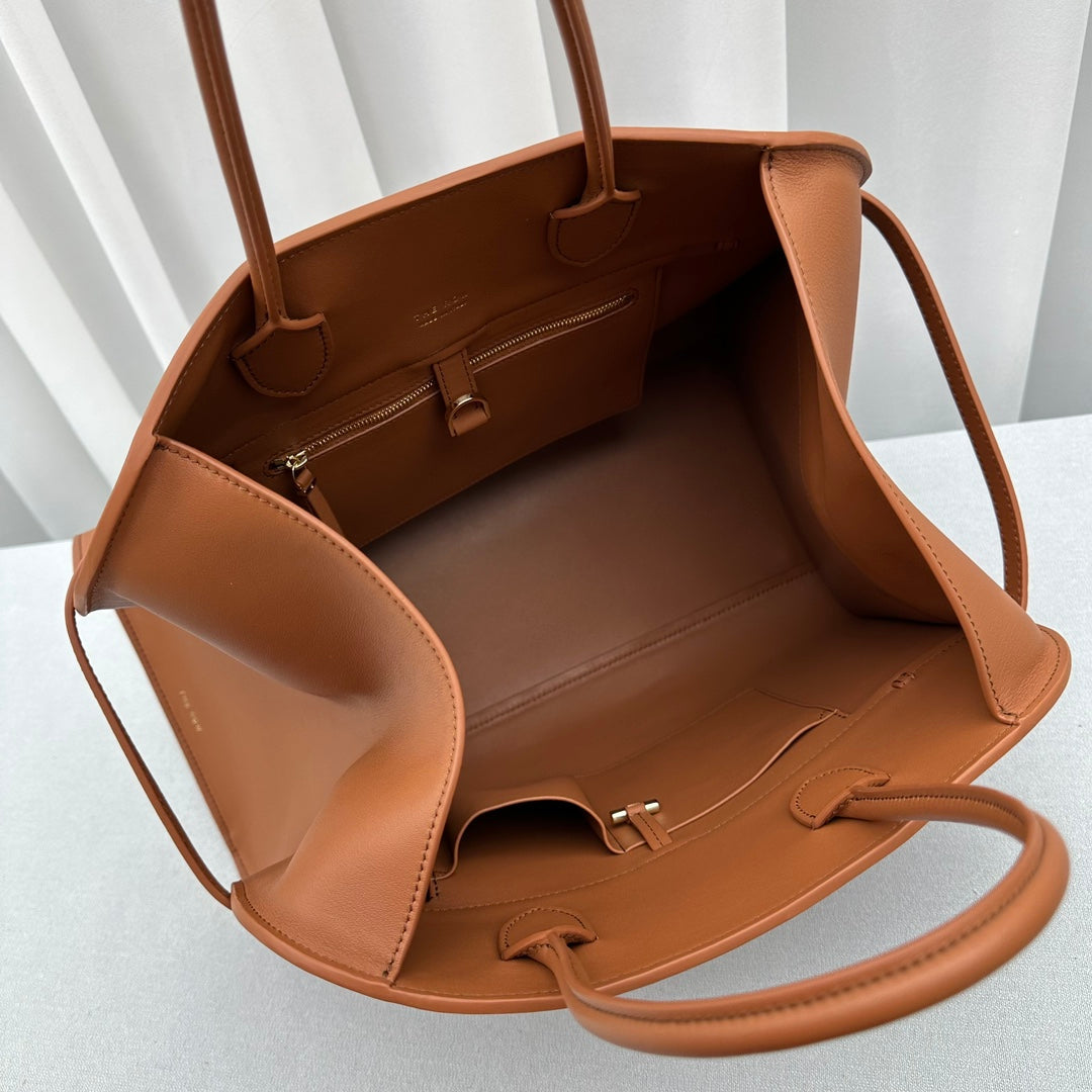 The Row W1255L72 Calfskin Margaux 15 Air buckled textured-leather tote T10991