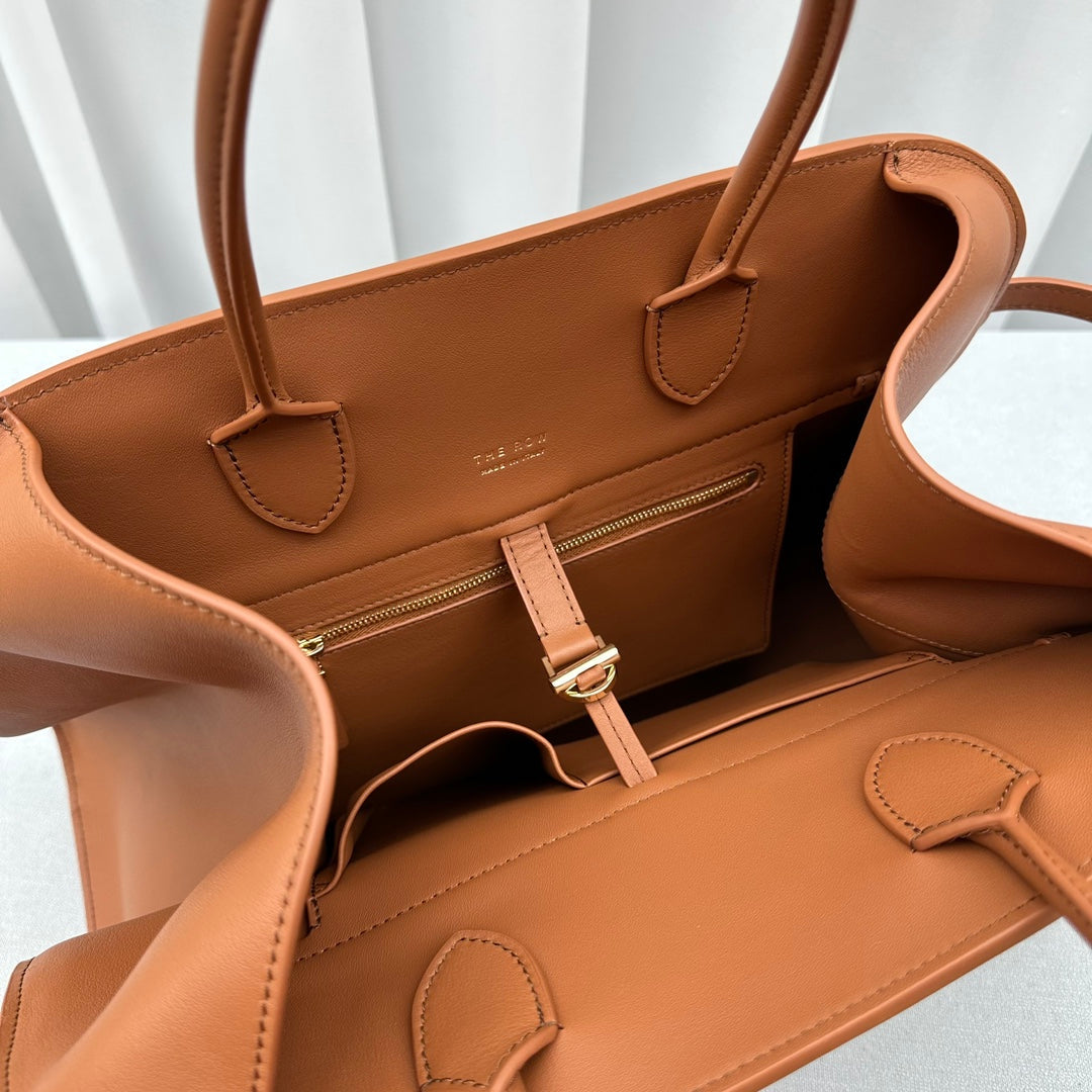 The Row W1255L72 Calfskin Margaux 15 Air buckled textured-leather tote T10991