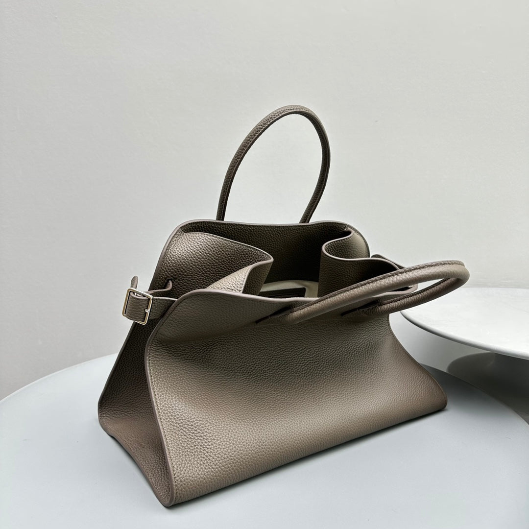The Row W1255L72 Calfskin Margaux 15 Air buckled textured-leather tote T10995