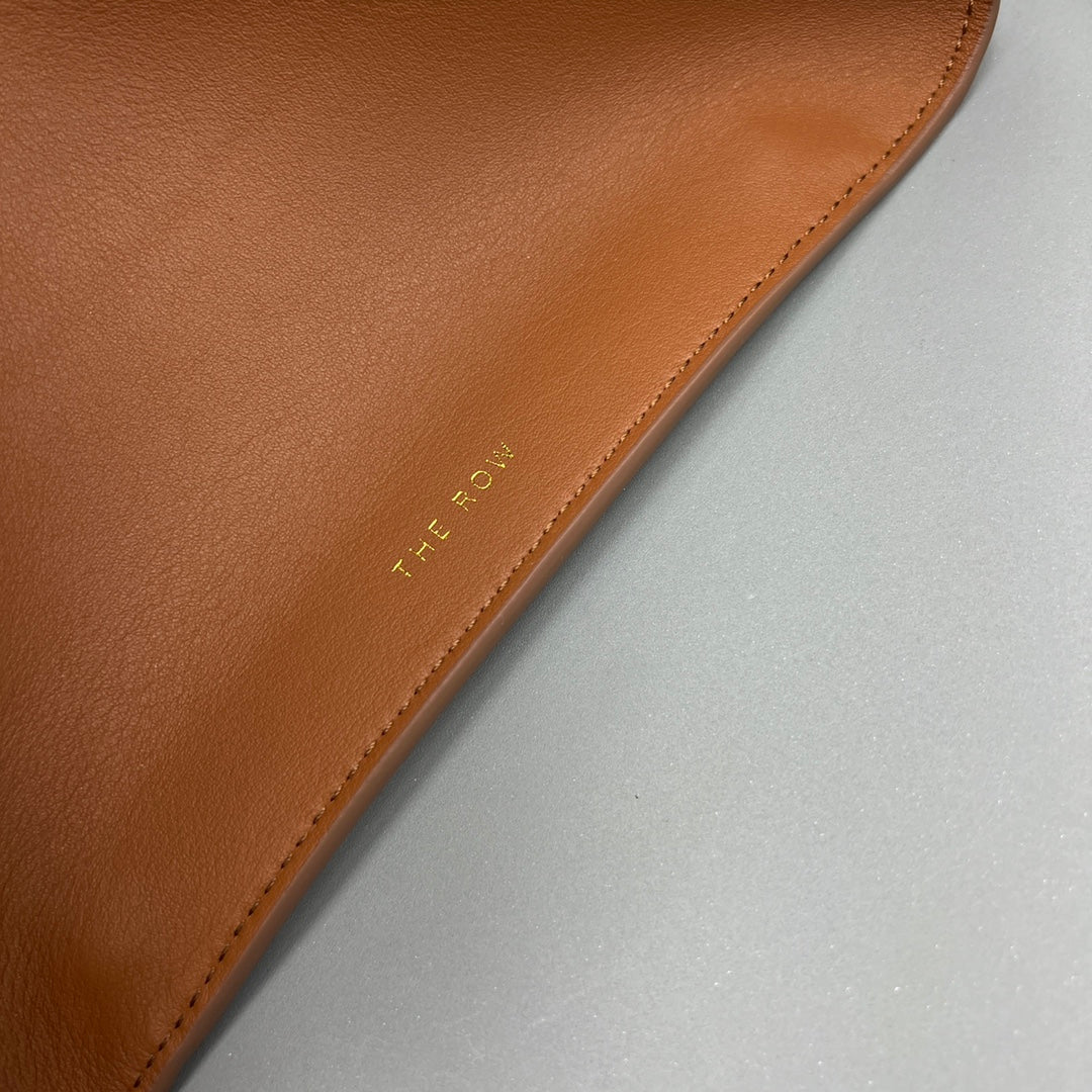 The Row W1255L72 Calfskin Margaux 15 Air buckled textured-leather tote T10996