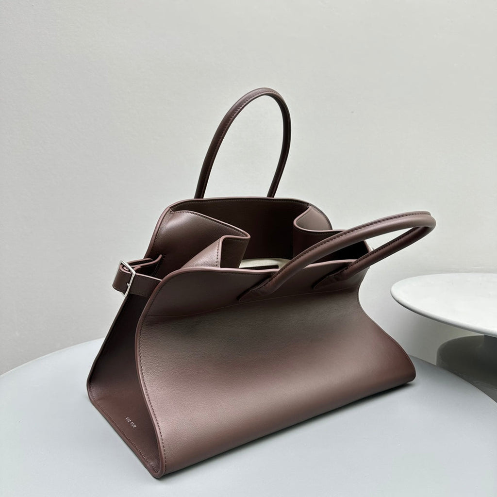 The Row W1255L72 Calfskin Margaux 15 Air buckled textured-leather tote T10997
