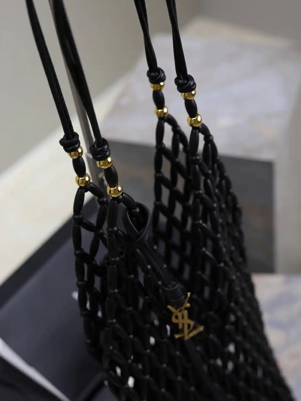 YSL 821911 supple bucket in wood beads Black